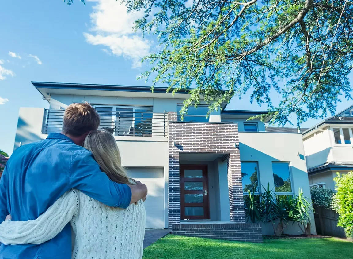 A couple looking toward a New Jersey home
